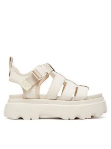 Ugg Sandały W Cora 1152698 Écru. Sandały Ugg, bez wzorów, z nubiku, bez obcasa, na płaskiej podeszwie, bez zapięcia. Za 509,99 zł.