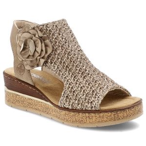 Beżowe Sandały Rieker Eleganckie Obuwie Damskie Na Koturnie. Brązowe sandały Rieker, bez wzorów, z materiału, bez obcasa, na koturnie, bez zapięcia. Za 359,00 zł.