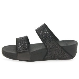 Kobiece klapki na koturnie FitFlop Lulu Slide. Czarne klapki FIT FLOP, bez wzorów, bez obcasa, na koturnie. Za 484,50 zł.