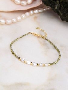 Pierres de Jade Pozłacana bransoletka z perłami i kryształami rozmiar: onesize. Białe bransoletki Pierres de Jade, z kryształem, pozłacane. Za 43,99 zł.