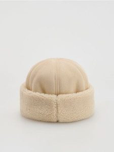 Czapka pilotka - złamana biel. Czapki Reserved, bez wzorów. Za 79,99 zł.