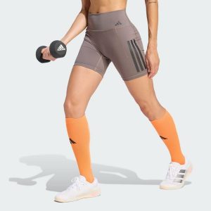 Krótkie legginsy Optime Workout 3-Stripes. Brązowe legginsy ADIDAS, bez wzorów, z lycry, z podwyższonym stanem, krótkie. Za 199,00 zł.