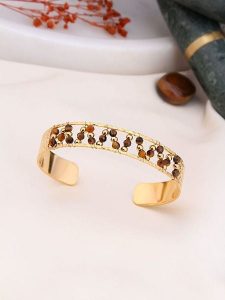 Charlize Pozłacana bransoletka z kryształami rozmiar: onesize. Brązowe bransoletki Charlize, z kryształem, pozłacane. Za 91,56 zł.