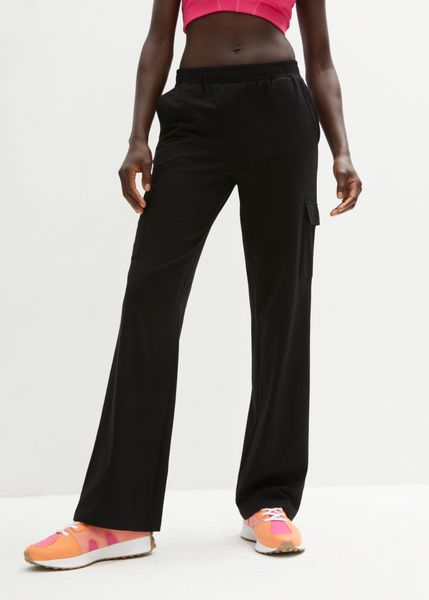 Spodnie sportowe z elastycznego materiału z bawełną. Czarne spodnie dresowe bonprix, bez wzorów, z bawełny. Za 114,99 zł.