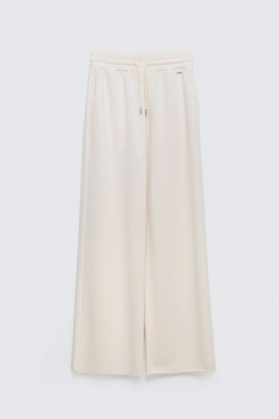 Spodnie damskie dresowe z szeroką nogawką kremowe Lunarap 102. Białe spodnie dresowe Big Star, l, bez wzorów, z dresówki. Za 179,99 zł.