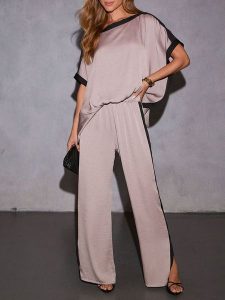 Milan Kiss Spodnie w kolorze szarobrązowo-czarnym rozmiar: M. Brązowe spodnie z wysokim stanem Milan Kiss, bez wzorów, z materiału, z podwyższonym stanem. Za 130,99 zł.