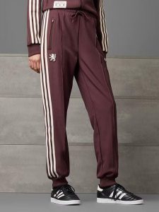 Adidas Spodnie dresowe "Olympique Lyonnais Terrace Icons" w kolorze czerwonym rozmiar: XL. Czerwone spodnie dresowe ADIDAS, xl, bez wzorów, z dresówki. Za 145,26 zł.