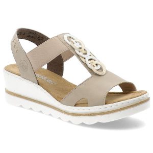 Beżowe Sandały Rieker Eleganckie Obuwie Damskie Na Koturnie. Brązowe sandały Rieker, z aplikacjami, z materiału, bez obcasa, na koturnie, bez zapięcia. Za 299,00 zł.