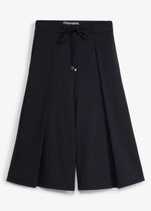 Spodnie sportowe o kroju culotte z ozdobnymi zakładkami, szybkoschnące. Czarne spodnie dresowe bonprix, bez wzorów. Za 117,99 zł.