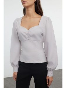 Trendyol Bluzka w kolorze białym rozmiar: 34. Białe bluzki Trendyol, bez wzorów, bez kołnierzyka, bez ramiączek. Za 60,99 zł.