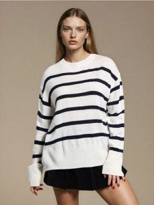 Sweter w paski - biały. Białe czapki Sinsay, bez wzorów. W wyprzedaży za 17,99 zł.