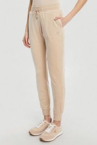 GUESS Beżowe damskie spodnie dresowe Couture, Rozmiar S. Brązowe spodnie dresowe Guess, s, z aplikacjami, z dresówki. W wyprzedaży za 217,99 zł.