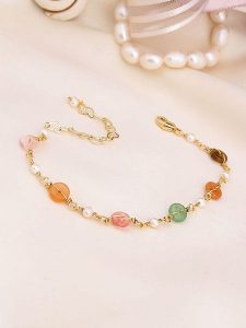 Pierres de Jade Pozłacana bransoletka z perłami i kocim okiem rozmiar: onesize. Białe bransoletki Pierres de Jade, z perłą, pozłacane. Za 43,99 zł.