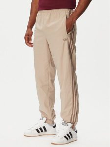 Adidas Spodnie dresowe Firebird KS7503 Beżowy Regular Fit. Brązowe spodnie dresowe ADIDAS, m, bez wzorów, z dresówki. Za 299,99 zł.