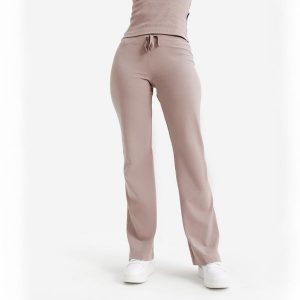 Rozszerzane legginsy damskie Elementals. Brązowe legginsy DECATHLON, bez wzorów, z bawełny. Za 89,99 zł.