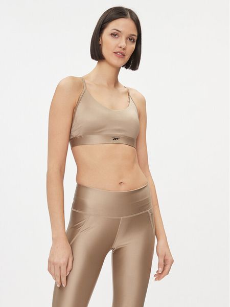 Reebok Biustonosz sportowy Holiday Lux IL4589 Beżowy. Brązowe biustonosze sportowe Reebok, bez wzorów, z syntetyku. Za 99,99 zł.