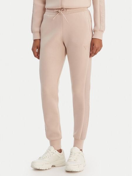 Guess Spodnie dresowe V2YB18 K7UW2 Beżowy Regular Fit. Brązowe spodnie dresowe Guess, xl, z aplikacjami, z dresówki. Za 399,99 zł.