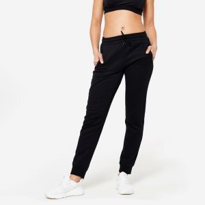 Spodnie dresowe damskie Domyos Gym & Pilates slim. Czarne spodnie dresowe DOMYOS, xl, bez wzorów, z dresówki. Za 89,99 zł.