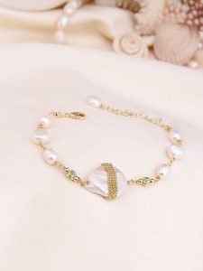 Pierres de Jade Pozłacana bransoletka z perłami rozmiar: onesize. Białe bransoletki Pierres de Jade, z perłą, pozłacane. Za 43,99 zł.