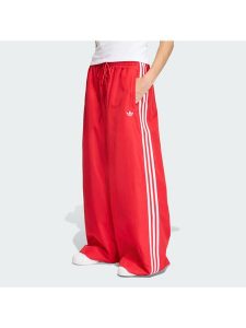 Adidas Spodnie dresowe Firebird Adilenium KD6299 Czerwony Regular Fit. Czerwone spodnie dresowe ADIDAS, xs, bez wzorów, z dresówki. Za 399,99 zł.