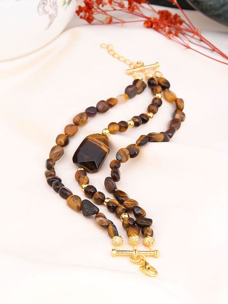 Pierres de Jade Pozłacana bransoletka z elementami ozdobnymi rozmiar: onesize. Brązowe bransoletki Pierres de Jade, pozłacane. Za 43,99 zł.