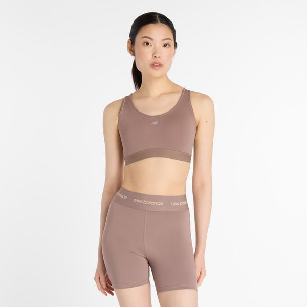 Biustonosz do biegania New Balance WB51032EAS – beżowy. Brązowe biustonosze New Balance, bez wzorów, z materiału. Za 169,99 zł.