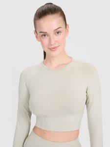 4F Longsleeve treningowy crop-top z wycięciem na plecach damski - beżowy M/L. Brązowe topy 4f, l, bez wzorów, bez kołnierzyka, bez ramiączek. W wyprzedaży za 59,99 zł.