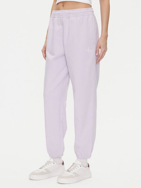Calvin Klein Jeans Spodnie dresowe Monologo LV047B235G Fioletowy Regular Fit. Fioletowe spodnie dresowe Calvin Klein Jeans, l, bez wzorów, z bawełny. Za 239,99 zł.