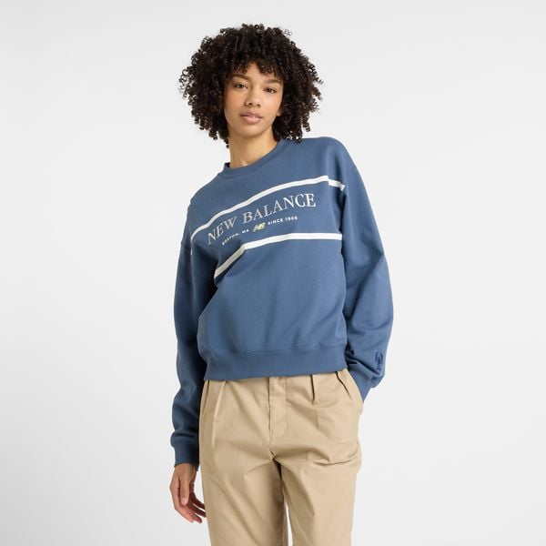 Bluza damska New Balance WT51923VTI – niebieska. Niebieskie bluzy New Balance, m, z aplikacjami, z bawełny, bez kaptura. Za 249,99 zł.