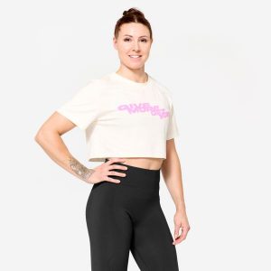 Koszulka fitness damska Domyos crop top. Białe bluzki DOMYOS, s, bez wzorów, z bawełny, sportowe, bez kołnierzyka, bez ramiączek. W wyprzedaży za 39,99 zł.