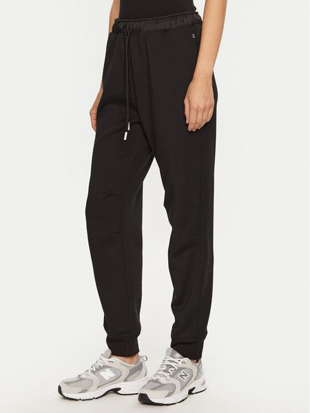 Champion Spodnie dresowe 117477 Czarny Slim Fit. Czarne spodnie dresowe Champion, s, bez wzorów, z dresówki. Za 149,99 zł.