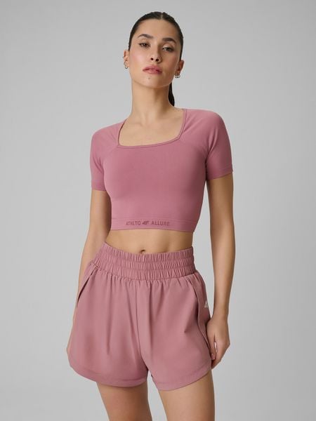 4F Crop top treningowy bezszwowy damski - różowy XS/S. Czerwone topy 4f, s, bez wzorów, z materiału, sportowe, bez kołnierzyka, bez ramiączek. Za 79,99 zł.