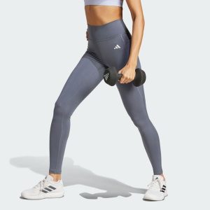 Długie legginsy Optimé Essentials z kieszonką na drobiazgi. Białe legginsy ADIDAS, bez wzorów, z podwyższonym stanem, długie. Za 199,00 zł.