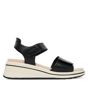 Sandały Caprice. Czarne sandały Caprice, bez wzorów, bez obcasa, na koturnie, bez zapięcia. Za 329,99 zł.