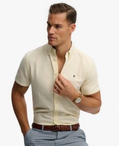 Superdry Koszula Preppy Oxford krótki rękaw Pastel Yellow Chambray. Żółte koszule Superdry, uniwersalny, bez wzorów, z bawełny, bez kołnierzyka, bez ramiączek. Za 301,95 zł.