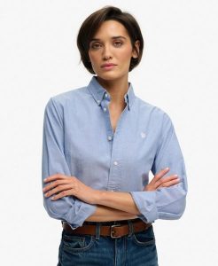 Superdry Damska Koszula Slim Oxford z Długim Rękawem z Bawełny Organicznej. Niebieskie koszule Superdry, bez wzorów, z bawełny, bez kołnierzyka, bez ramiączek. Za 314,00 zł.