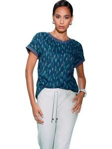 Heine Bluzka w kolorze niebiesko-zielonym rozmiar: 42. Niebieskie bluzki Heine, bez wzorów, z wiskozy, bez kołnierzyka, bez ramiączek. Za 35,35 zł.