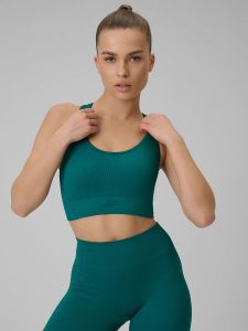 4F Biustonosz treningowy bezszwowy z niskim wsparciem damski - turkusowy XS/S. Niebieskie biustonosze 4f, bez wzorów, z materiału. Za 89,99 zł.