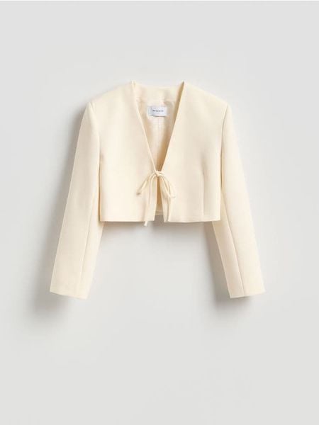 Krótka marynarka z wiązaniem - złamana biel. Marynarki i żakiety Reserved, l, bez wzorów, z tkaniny. Za 199,99 zł.