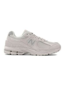 New Balance Skórzane sneakersy "2002R" w kolorze kremowym rozmiar: 37,5. Brązowe trampki New Balance, bez wzorów, z materiału, bez zapięcia. Za 543,99 zł.