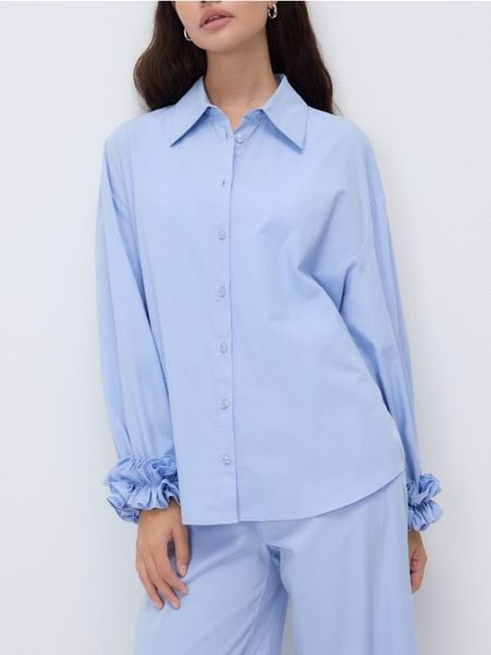 Koszula z dekoracyjną falbaną - jasnoniebieski. Niebieskie koszule Reserved, l, bez wzorów, z bawełny, bez kołnierzyka, bez ramiączek. Za 129,99 zł.