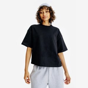 Koszulka Crop damska. Czarne bluzki DECATHLON, m, bez wzorów, z bawełny, bez kołnierzyka, bez ramiączek. Za 54,99 zł.
