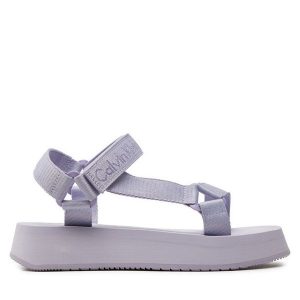 Sandały Calvin Klein Jeans. Fioletowe sandały Calvin Klein Jeans, bez wzorów, z jeansu, bez obcasa, na płaskiej podeszwie, bez zapięcia. Za 299,99 zł.