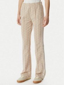 Lacoste Spodnie dresowe XF9313 Beżowy jasny Regular Fit. Brązowe spodnie dresowe Lacoste, bez wzorów, z dresówki. Za 493,99 zł.