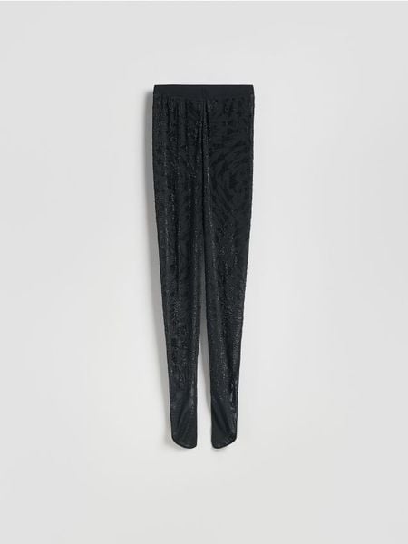 Legginsy z ozdobną aplikacją - czarny. Czarne legginsy Reserved, z aplikacjami, z dzianiny. Za 199,99 zł.