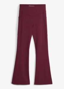 Wygodne legginsy sportowe z kieszonką na telefon i poszerzanymi nogawkami, z szybkoschnącego materiału. Czarne legginsy bonprix, bez wzorów, z materiału. Za 124,99 zł.