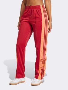 Adidas Spodnie dresowe w kolorze czerwono-pomarańczowym rozmiar: XL. Czerwone spodnie dresowe ADIDAS, xl, bez wzorów, z dresówki. Za 204,96 zł.