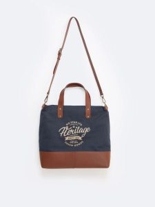 Torba unisex ze skórzanymi elemantami granatowo-brązowa Arvis 00. Brązowe shopper bag Big Star, z aplikacjami, z lakierowanej skóry, przez ramię, duże, lakierowane, bez dodatków. W wyprzedaży za 299,99 zł.