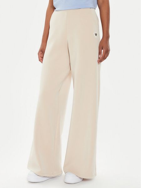 Guess Spodnie dresowe V4YB07 KCAY2 Beżowy Relaxed Fit. Brązowe spodnie dresowe Guess, xl, z aplikacjami, z dresówki. Za 394,99 zł.