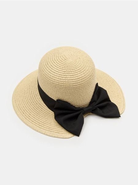 Kapelusz z dekoracyjną czarną kokardą - kremowy. Białe kapelusze Sinsay, bez wzorów. Za 25,99 zł.